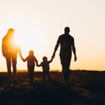 Happy family silhouette on the sunset