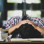 Educational conept: tired student in a library