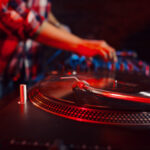 Cute dj woman having fun playing music at club party