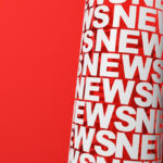 White tube made of news letters on the red background with copy space.