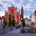 People at Franciscan Church Annunciation Triple Bridge Ljubljana Slovenia evening