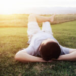 Rexation man on green grass.