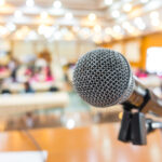 Black microphone in conference room .