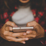 Close up of woman’s hands holding smartphone. Hipster girl with