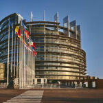 European Parliament building in Strasbourg, France with a clear blue sky in the background